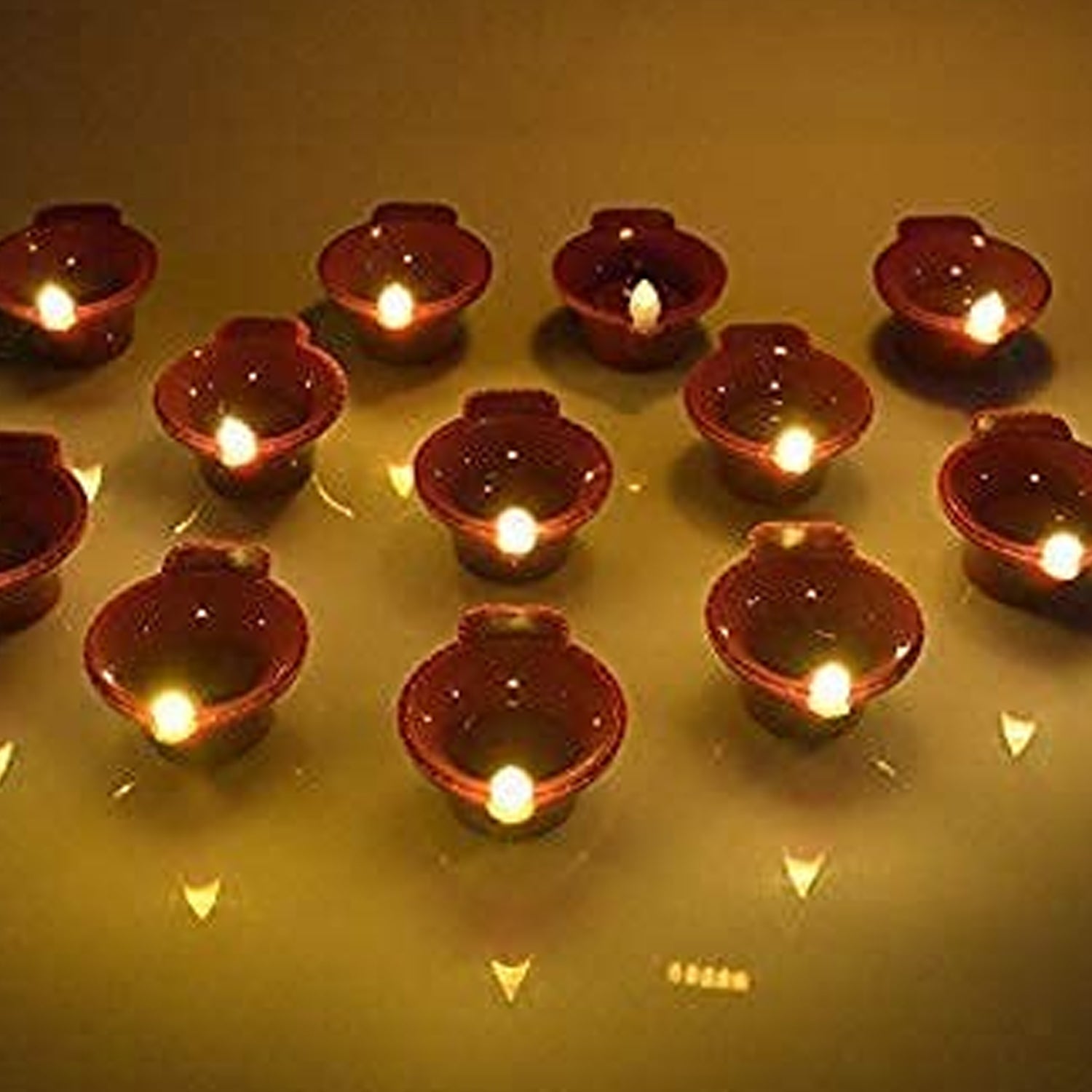 A group of glowing Water Sensor Diyas arranged for Diwali decoration.